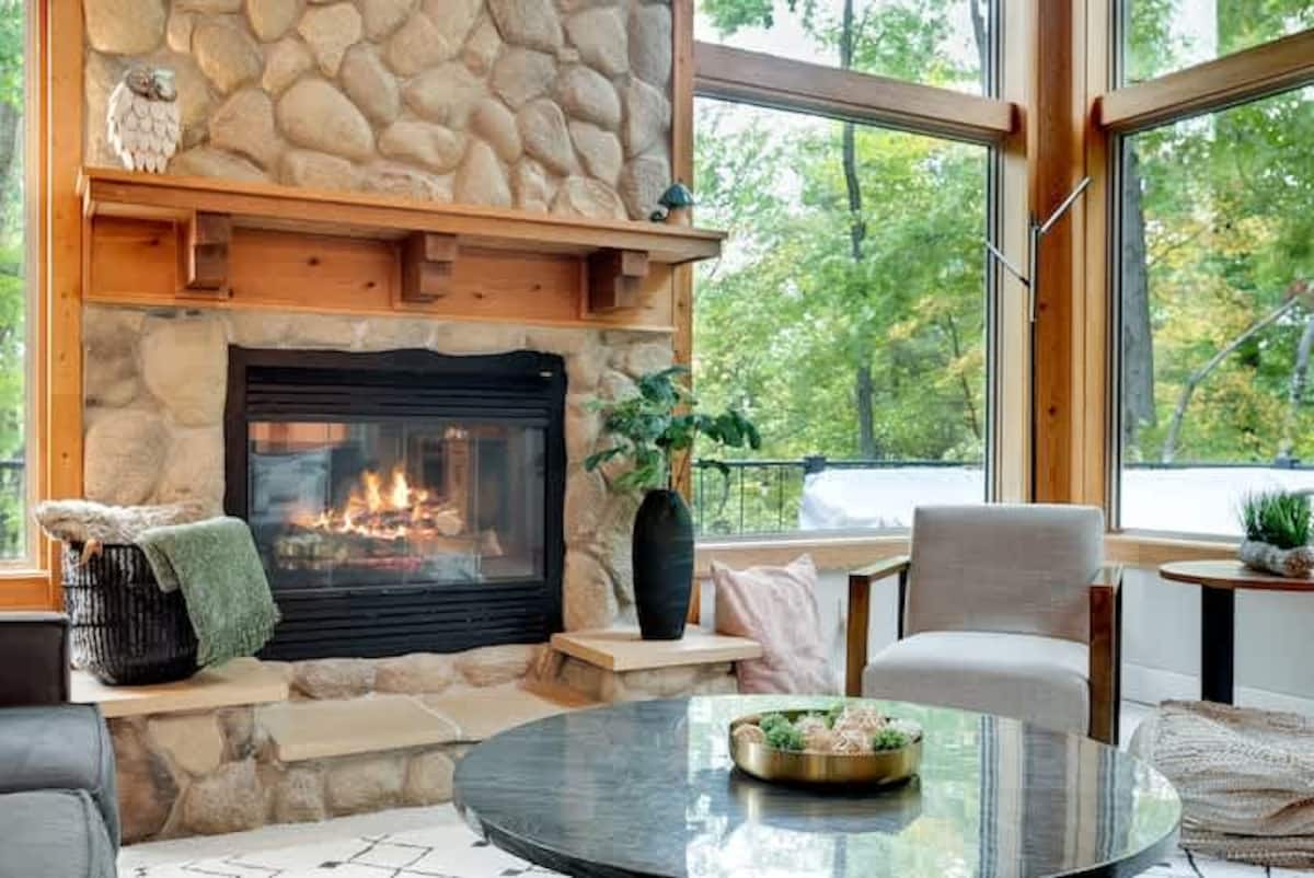 Grand stone fireplace in the great room with warm ambient lighting