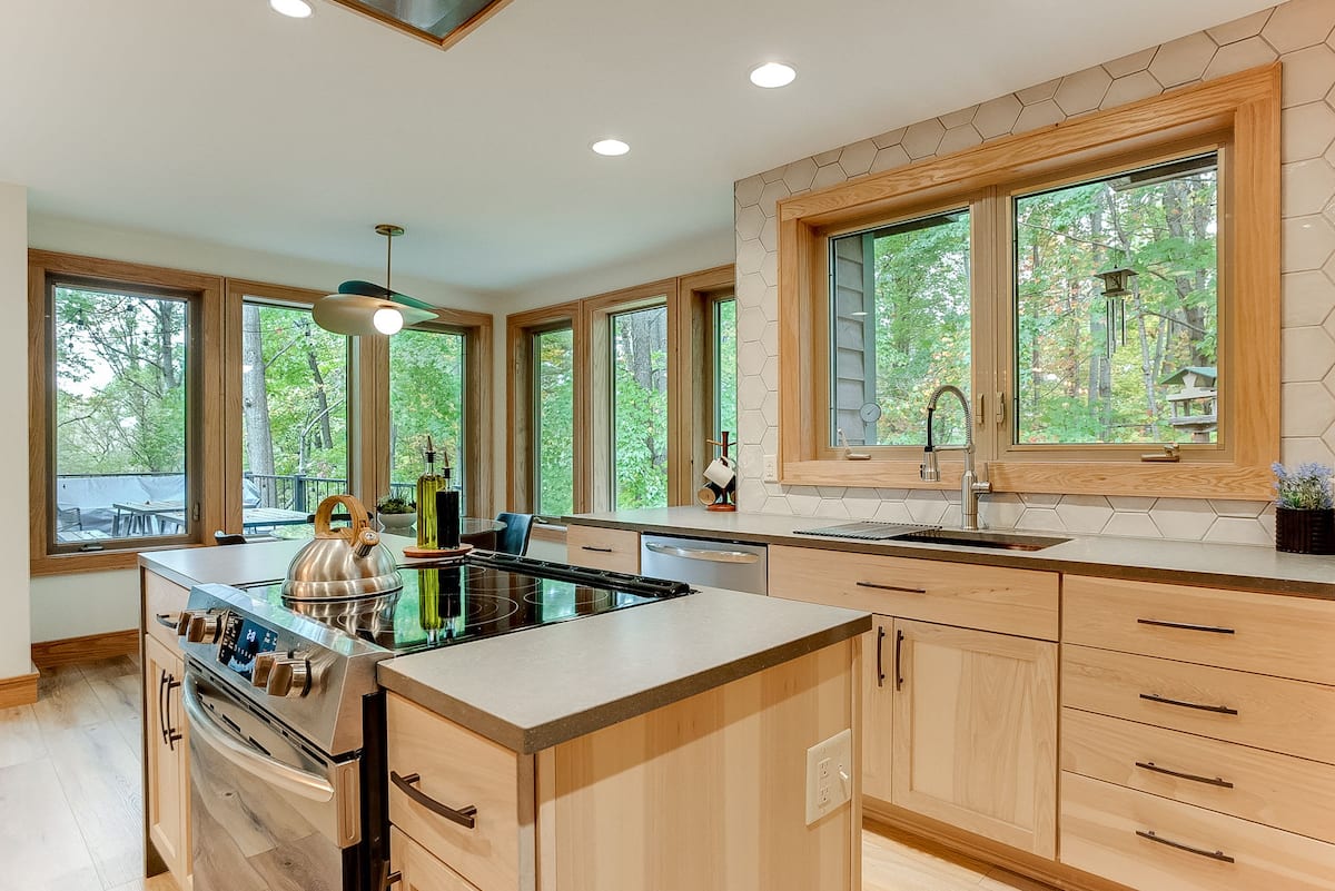 Chef's kitchen with island, stainless appliances, and panoramic windows