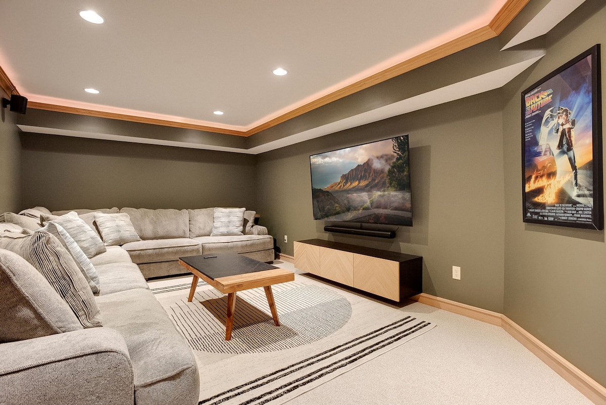 Private theater room with 75-inch TV, Sonos surround sound, and oversized sectional
